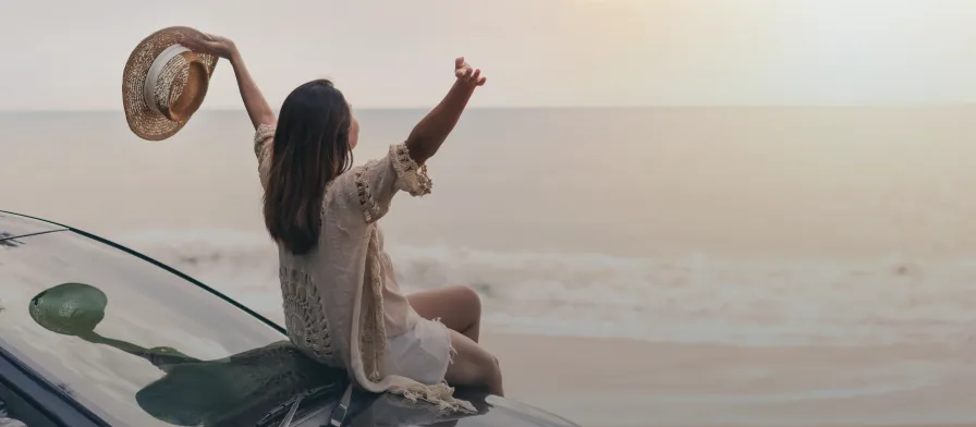 A GetMed traveler excited to be at the beach during their summer travel assignment.