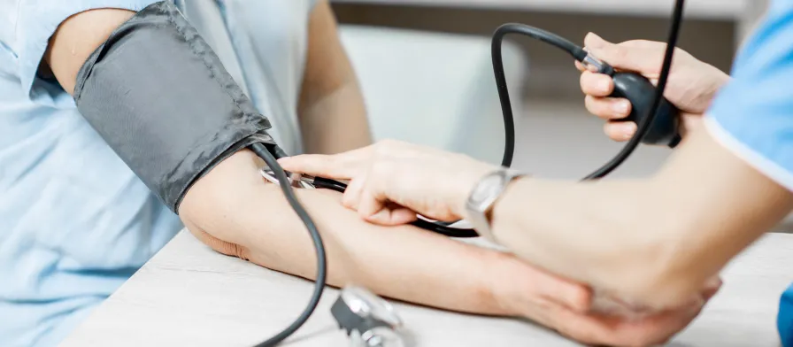 CNA Taking Blood Pressure on a Patient - How to become a traveling CNA GetMed Staffing